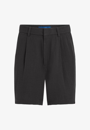 Mustad tekstuuriga põlveni ulatuvad lühikesed püksid vöökandide, esiplaanide ja peidetud esiistmega.