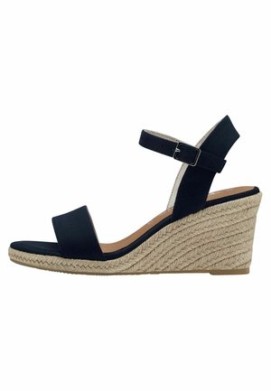 Navy blue wedge sandal featuring a soft fabric upper, wide footbed strap, adjustable ankle strap, and woven jute midsole.