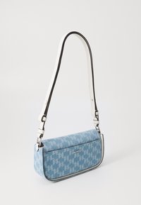 Bolso de mezclilla con patrón de pata de gallo azul. Cuenta con una correa blanca y negra y una placa de logo plateada. Forma rectangular con cierre de cremallera.