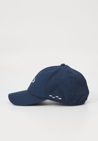 Navy blue baseball cap with perforated panels, curved peak, and a reflective logo. Features three white dots on the side for accent.