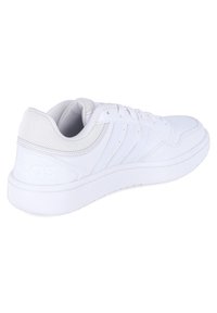 White athletic sneakers with smooth leather upper, mesh accents, rounded toe, and flat rubber sole. Features three stripe design on side.