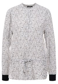 Haut à manches longues en tissu léger avec un motif floral blanc et marron. Il présente un col rond, une taille à cordon de serrage et des poignets noirs.