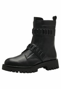 Black leather ankle boots featuring oversized buckles, a square toe, and a chunky tread sole. Upper has a smooth texture with decorative accents.
