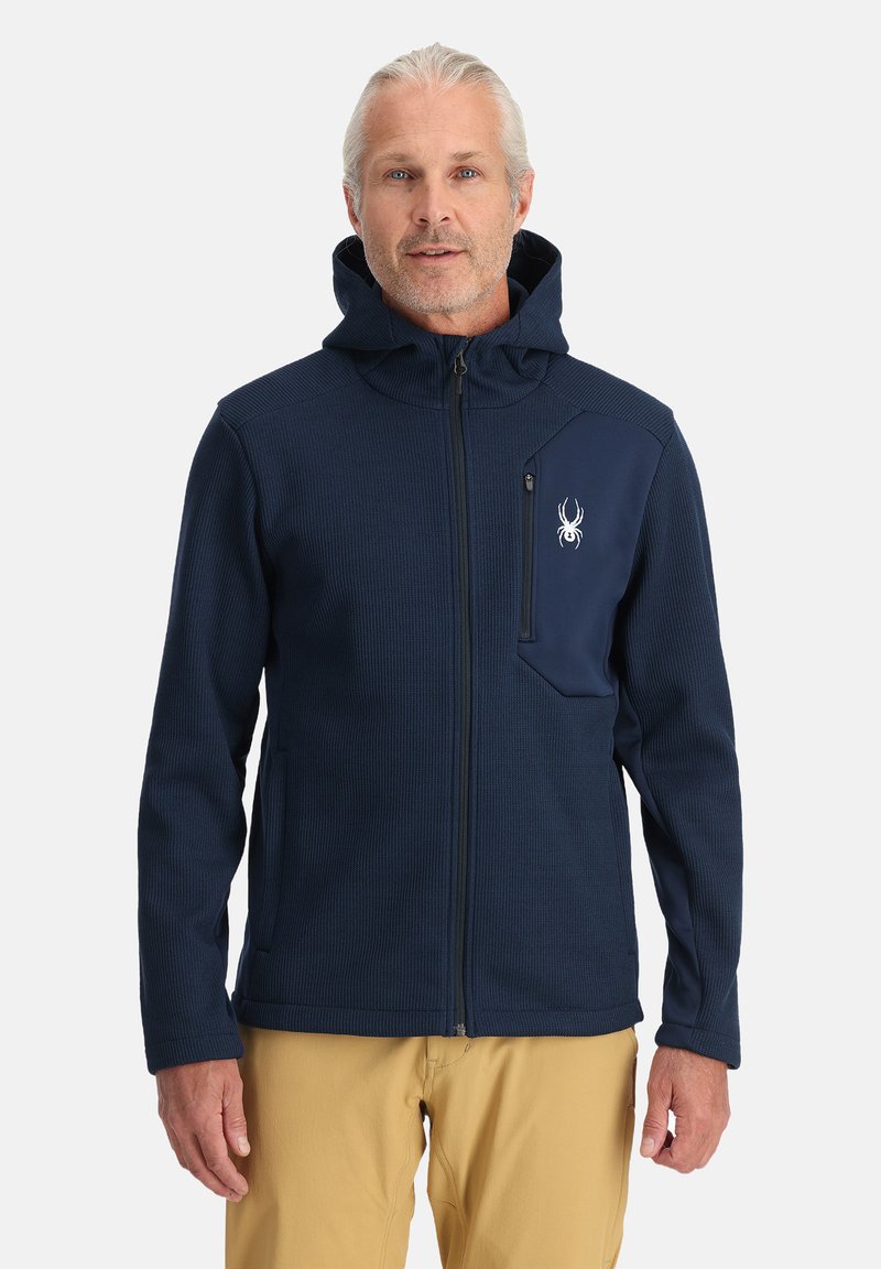 Marineblauwe zip-up hoodie van textuurstof, met een verstelbare capuchon en een borstzak met een contrasterend paneel en logo.