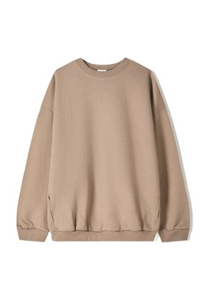 Sweatshirt oversize de couleur brun clair, avec des manches longues et un col et des poignets côtelés, présenté à plat sur un fond blanc.