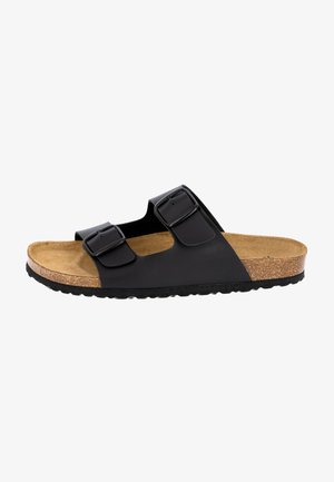 Black two-strap sandals with adjustable buckles, cork footbed, textured rubber sole, and a minimalistic design.