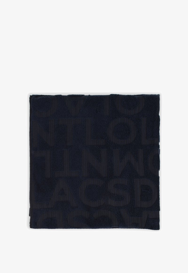 Cotton towel in deep navy with a textured design featuring large embossed letters. Soft terry cloth material with a flat woven border.