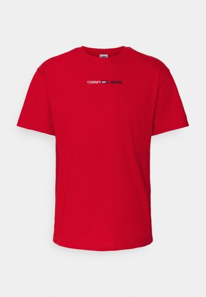 Czerwona koszulka z krótkim rękawem, okrągłym dekoltem i małym białym, niebieskim i czarnym logo "Tommy Jeans" na środku klatki piersiowej.