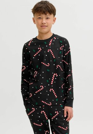 Svart pyjamas-set med långa ärmar, med mönster av godisrör och hollyblad i kombination med vita prickar. Gjord av mjukt tyg med ribbade manschetter.