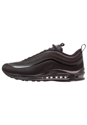 Zapatilla Nike Air Max 97 negra con parte superior de patrón ondulado, suela con amortiguación visible de aire y tiradores en la lengüeta y el talón.