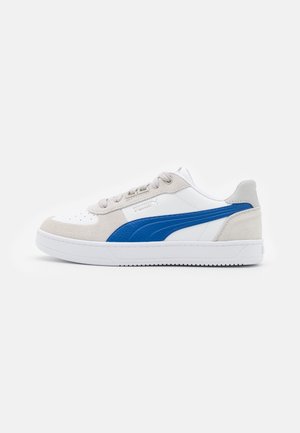 White and gray sneakers with blue accents, suede and leather material, lace-up closure, perforated toe, textured sides, rubber sole.