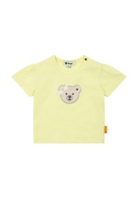 Gelbes Baumwoll-T-Shirt mit kurzen Puffärmeln, vorne mit einer Bärenkopf-Applikation und einem Seitenetikett mit dem Markenlogo.