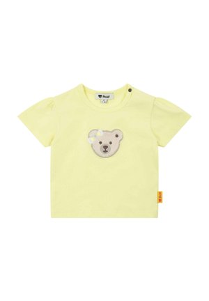 Gelbes Baumwoll-T-Shirt mit kurzen Puffärmeln, vorne mit einer Bärenkopf-Applikation und einem Seitenetikett mit dem Markenlogo.