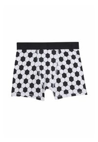 Pantalones cortos de boxeo en blanco y negro con un patrón hexagonal, que presentan una cinturilla negra y costuras en contraste. La tela de algodón ofrece una textura suave.