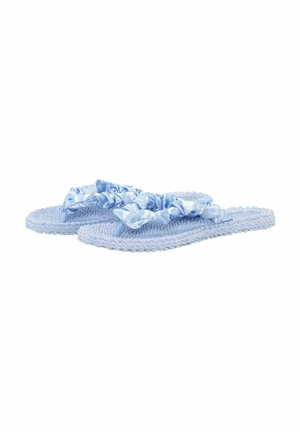 Lyseblå vævede flip-flops med flæsebelagte satinremme placeret side om side på en hvid baggrund.