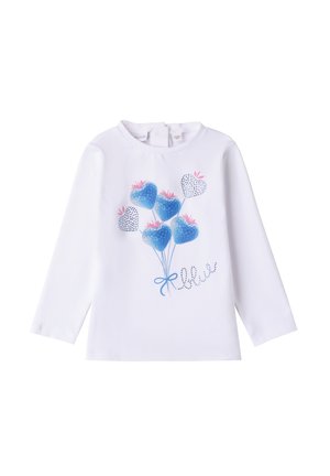 Chemise à manches longues blanche avec un design de ballon bleu orné de cœurs et d'accents roses, embellie de détails scintillants et d'un nœud bleu.