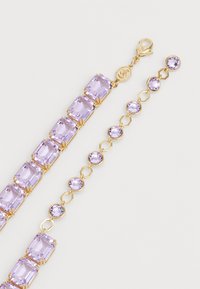 Gold-tone bracelet featuring rectangular and circular lavender stones with a smooth finish, connected by gold accents and a lobster clasp.