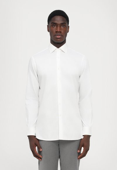 White button-up shirt with a classic collar, long sleeves, and a smooth texture. Notable for its simple design and neutral color.
