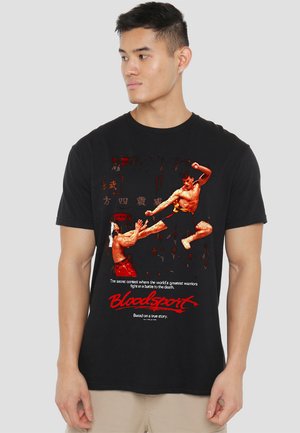 Black t-shirt featuring a graphic print of martial artists fighting, with red accents and text "Bloodsport" at the bottom.