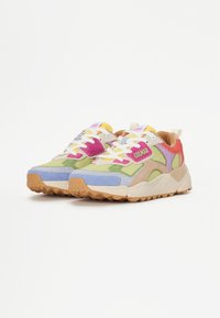 Multicolored sneakers featuring suede and mesh materials, a chunky profile, rubber outsole, and prominent branding on the sides.