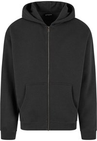 Felpa nera con zip realizzata in tessuto morbido, dotata di zip frontale, due tasche anteriori e cappuccio con cordino. Polsini e orlo a coste.