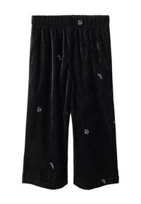 Čierne sametové nohavice s elastickým pásom, zdobené malou bielou kvetinovou výšivkou rozloženou po celom materiáli.