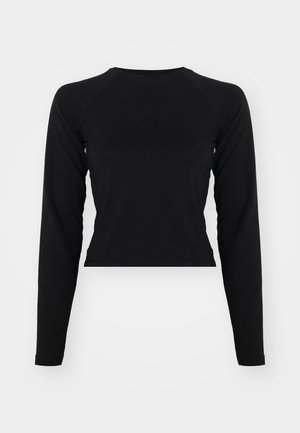 Sort langærmet crop top med rund hals og raglanærmer. Glat tekstur, minimalistisk design og ingen synlige mønstre eller hardware.