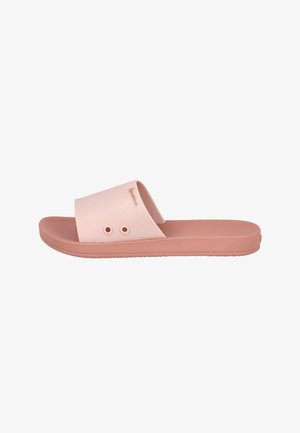 Chanclas rosas hechas de goma texturizada, con una tira ancha que presenta dos cortes circulares y una suela plana. Diseño simple y minimalista.