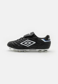 Black soccer cleat made of leather with a textured finish. Features silver accents and a Velcro strap, designed for traction with visible studs.