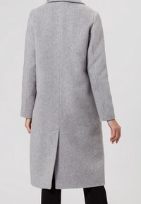 Cappotto grigio in lana con colletto a punta, maniche lunghe e spacco sul retro. Texture liscia con una vestibilità sagomata, che arriva fino a metà polpaccio.