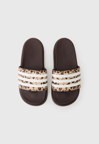 Adidas slides with a brown base, featuring a leopard print strap with three white stripes across the top. Flat design, made of synthetic material.
