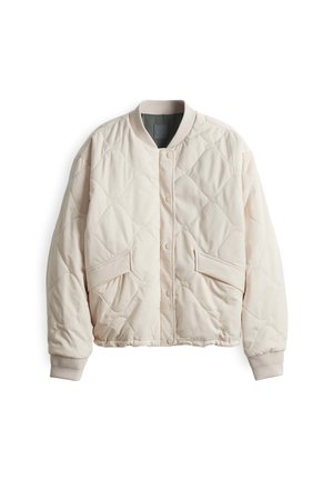 Veste matelassée beige clair avec un col rond, fermeture à bouton-pression et deux grandes poches avant. Manches à poignets et texture douce.