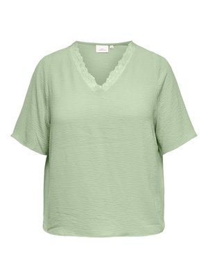 Blouse vert clair à manches courtes texturée avec un col en V en dentelle festonnée et une coupe décontractée.