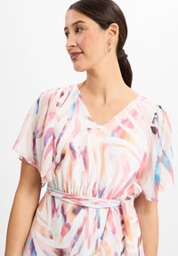 Flowy dress with a V-neckline, featuring a multicolored abstract pattern in pastel shades. Lightweight, sheer fabric with short flutter sleeves.