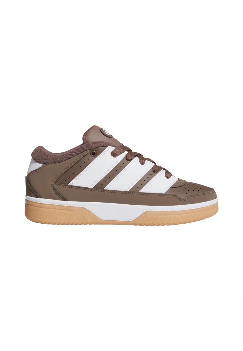 Brown leather athletic shoe with white accents, featuring a rubber sole, perforated toe, and brown laces. Distinct logo on the tongue.