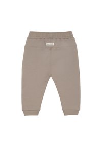Beige bomullsjoggers med resår i midjan, smalnade anklar och en liten logotyp broderad i övre mitten bak.
