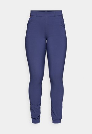 Leggings bleu marine fabriqués dans un matériau extensible, avec une texture lisse et une coupe ajustée, dotés de poches latérales et de coutures discrètes.