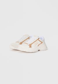 White sneakers with light brown accents, a textured upper, and a chunky sole. Features include laces and branding on the side.
