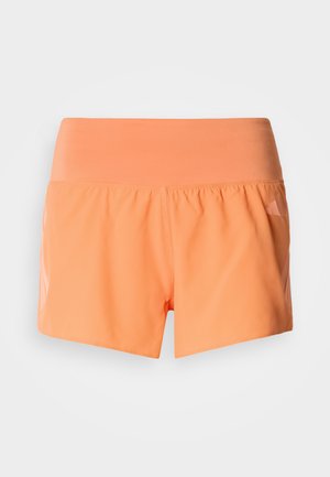 Oransje treningsshorts med en glatt, elastisk midjebånd. Løs passform med et lett stoff. Har en lett skinnende tekstur på sidene.
