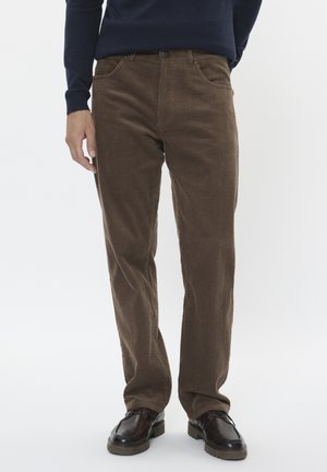 Brown corduroy trousers with a ribbed texture, straight fit, five-pocket design, and a button closure, paired with dark shoes.