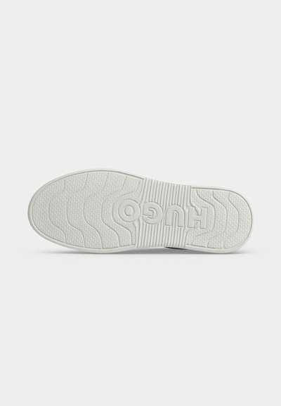 Semelle de chaussure blanche avec un motif adhérent texturé et le nom de la marque "HUGO" embossé en grandes lettres au centre.