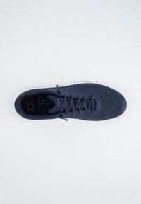 Marineblaue Sportschuhe mit Mesh-Obermaterial, ausgestattet mit einer strukturierten Oberfläche, runder Zehenform und weißer Sohle. Schnürsenkel und Logodetails auf der Innensohle.