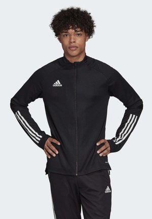 Zwarte athletic jack met rits en een witte Adidas-logo en drie witte strepen op de mouwen, met een aansluitend ontwerp en textielstof.