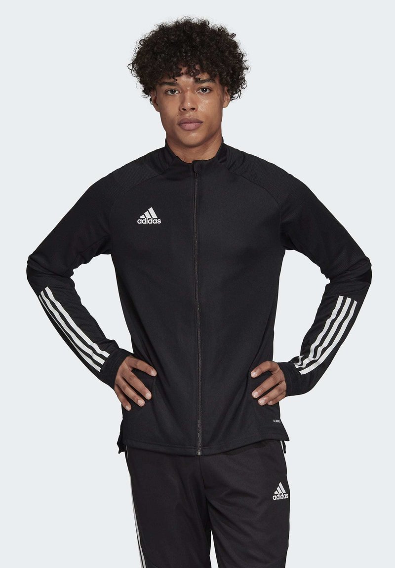 Zwarte athletic jack met rits en een witte Adidas-logo en drie witte strepen op de mouwen, met een aansluitend ontwerp en textielstof.