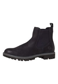 Botas de cuero negro hasta el tobillo con paneles laterales elásticos, talón reforzado y suela de goma texturizada con patrones de relieve prominentes.
