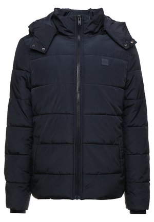 Veste rembourrée bleu marine avec fermeture éclair, col montant et capuche amovible. Motif matelassé horizontal et poches latérales. Matériau doux.