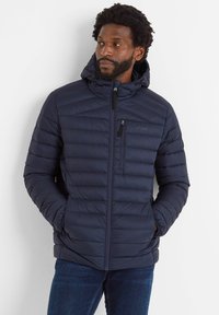 Navy padded jacket with a hood, vertical stitching for texture, zippered chest pocket, and elastic cuffs. Worn with blue jeans.