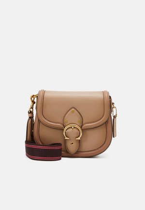 Tan leather crossbody bag with gold buckle detail and detachable black strap with red stripes on a white background.