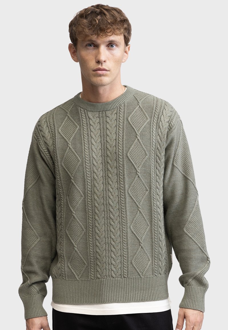 Olive green knitted sweater with diamond and cable patterns, a crew neck, ribbed cuffs, and hem; textured fabric, relaxed fit.