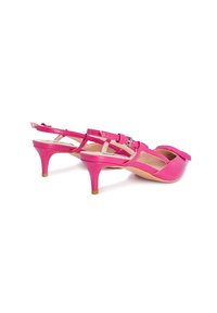 Tacchi in vernice rosa con un accento a fiocco, schiena aperta e design a striscia incrociata. Tacco sottile con una finitura testurizzata.